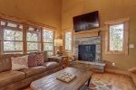 Cloud 9 Cabin living room with big screen and gas fire place. 